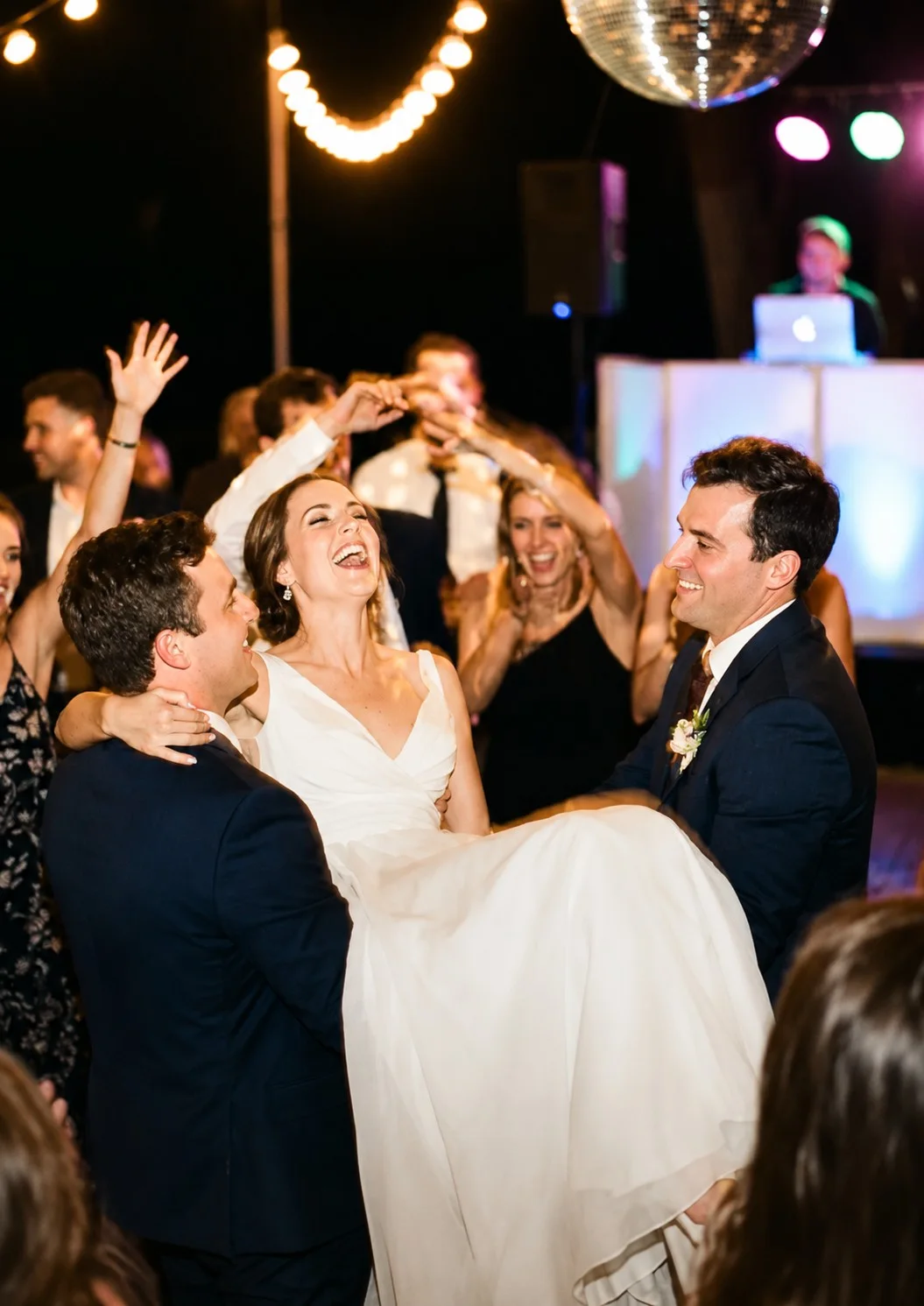 A reception with guests’ photos on a big-screen live wall as the couple dances.